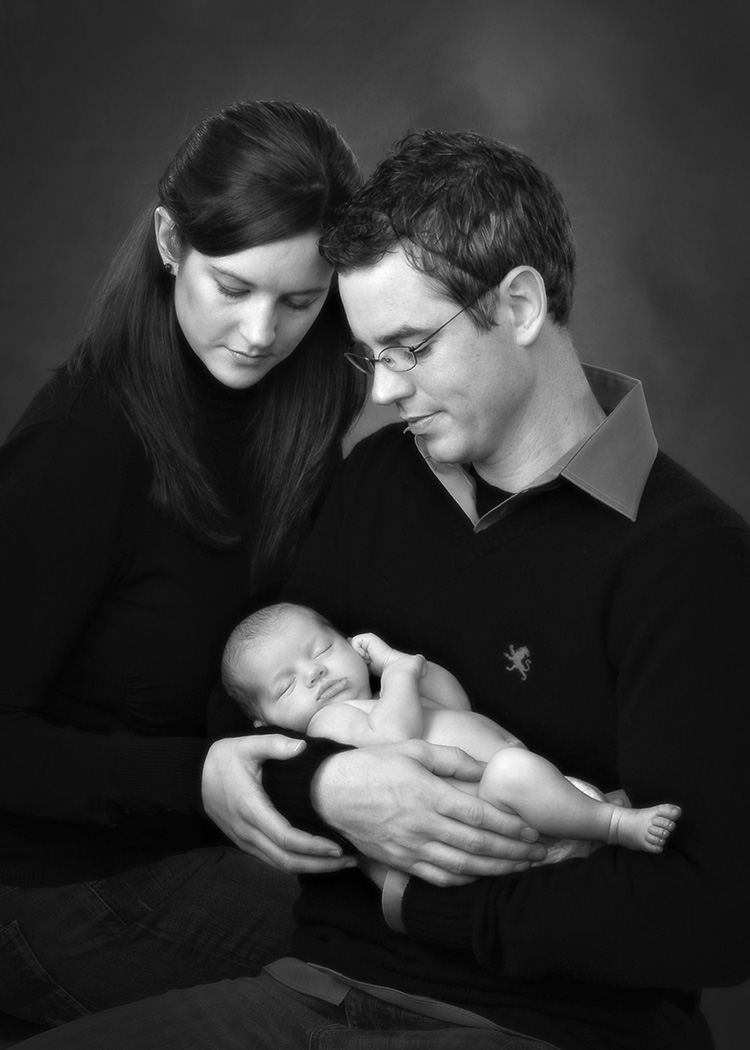 close up portrait of Mom and Dad holding baby by Dan Cleary of Cleary Creative Photography in Dayton Ohio