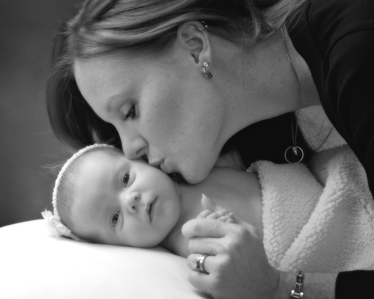 Mom kissing laying down baby portrait by Cleary Creative Photography in Dayton Ohio