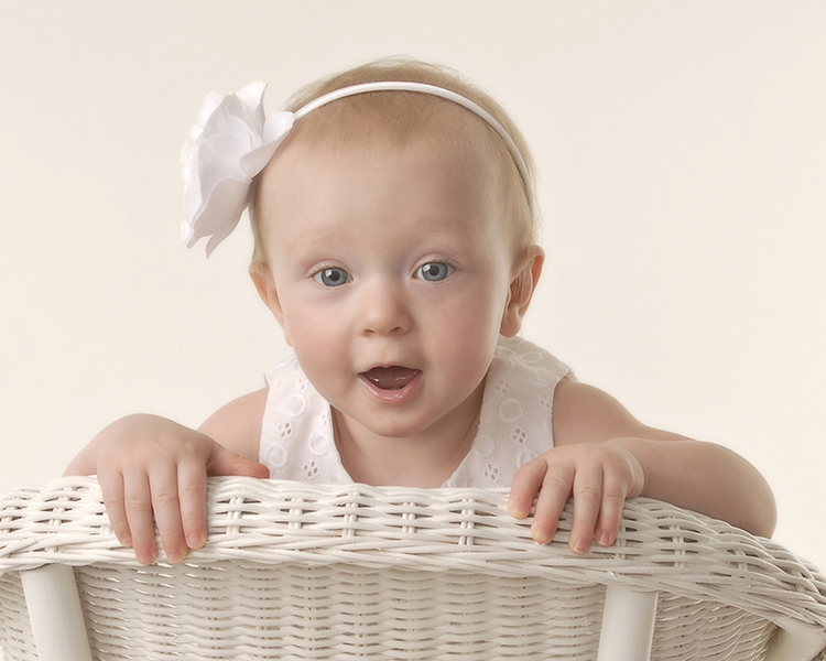 one year old baby girl sitting backwards on a chair by Dan Cleary of Cleary Creative Photography of Dayton Ohio