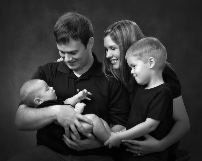portrait of young family holding 3 month old baby by Cleary Creative Photography in Dayton Ohio