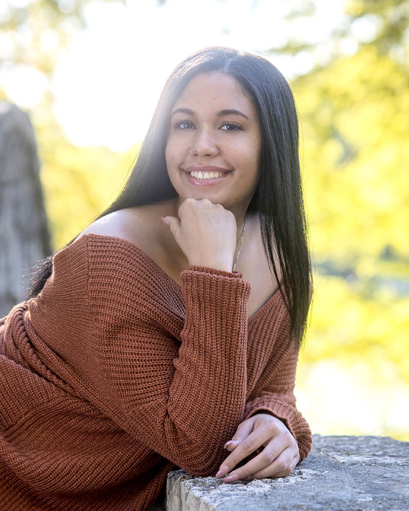 outdoor portrait of high school senior girl leaning on stone bridge by Dan Cleary of Cleary Creative Photography in Dayton Ohio