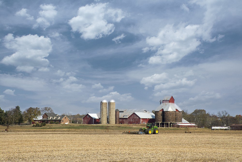 Farmer plowing field Tipp City Ohio by Dan Cleary of Cleary Creative Photography in Dayton Ohio