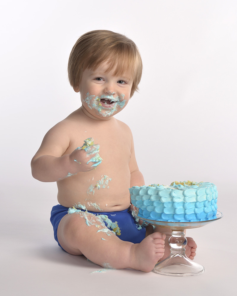 portrait of 1 year old baby boy eating cake by Dan Cleary of Cleary Creative Photography in Dayton Ohio