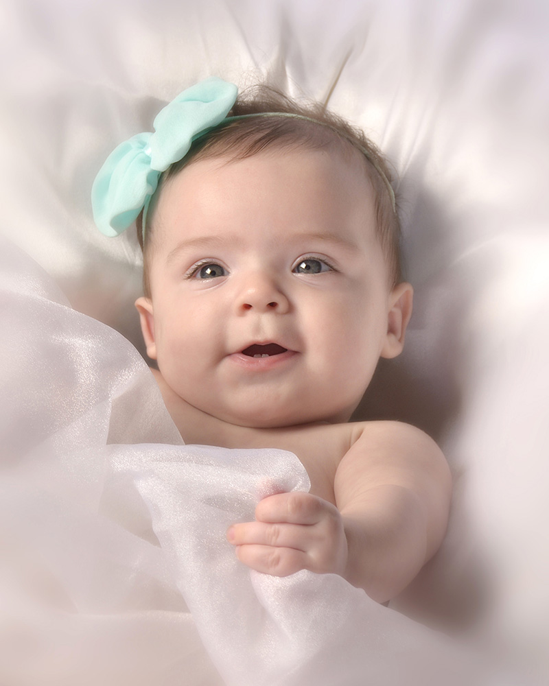 portrait of 3 month baby girl with blue head band by Dan Cleary of Cleary Creative Photography in Dayton Ohio