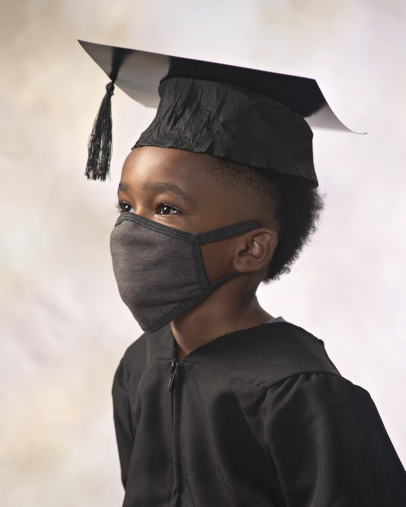 Kindergarten graduate with mask on by Dan Cleary of Cleary Creative Photography