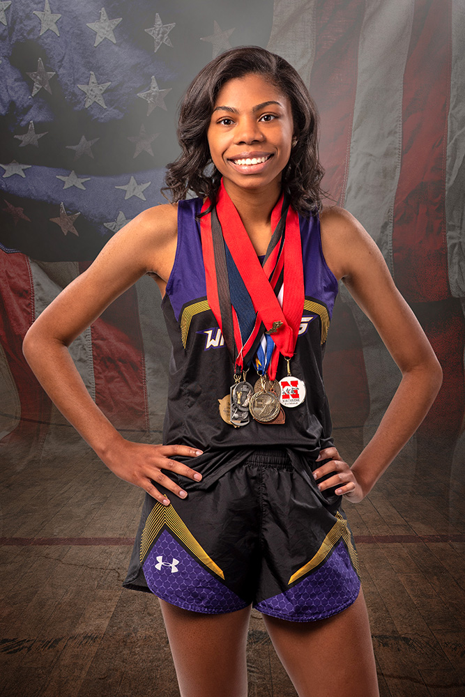 High school senior track runner with American flag by Dan Cleary of Cleary Creative Photography in Dayton Ohio