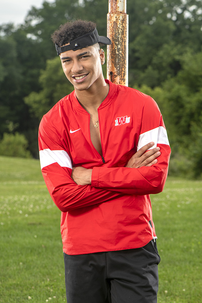 high school senior football player running outdoors by Dan Cleary of Cleary Creative Photography in Dayton, Ohio