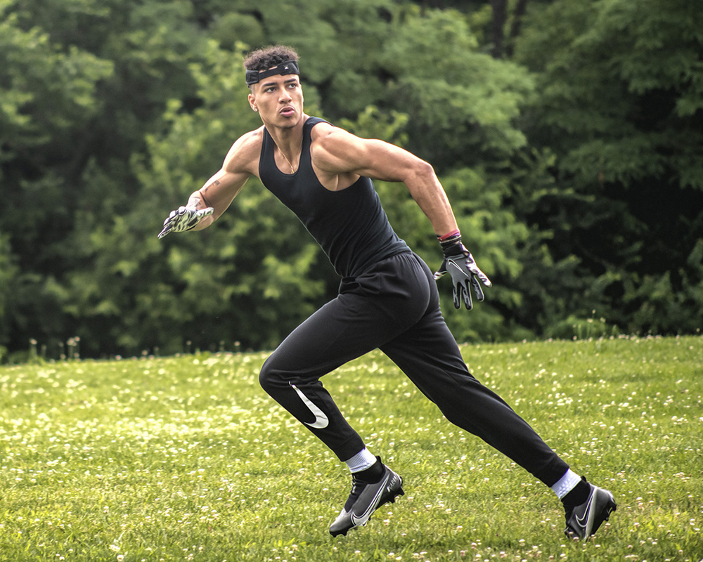 portrait of high school senior football player running outdoors by Dan Cleary of Cleary Creative Photography in Dayton, Ohio