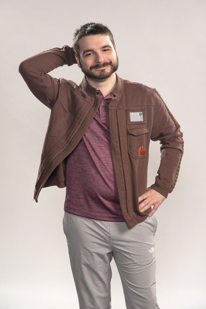 Actor in brown jacket standing pose by Dan Cleary
