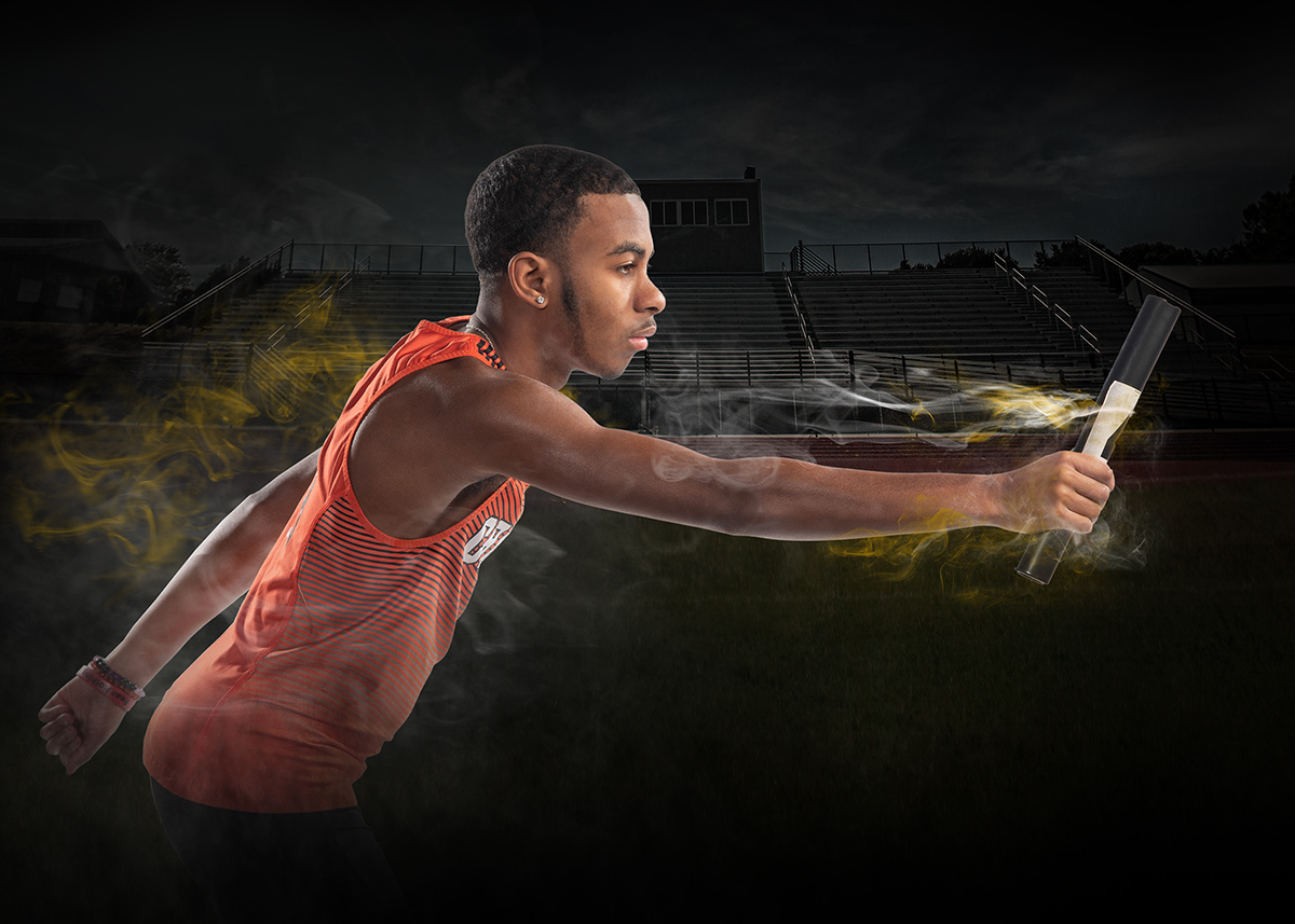 high school senior boy running track passing the batton by Dan Cleary Dayton Ohio