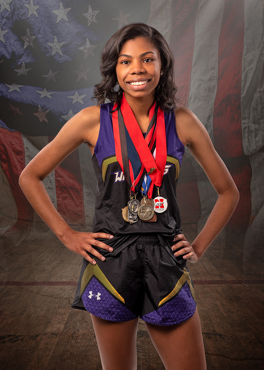 high school senior portrait girl with track metals and American Flag by Dan Cleary dayton Ohio