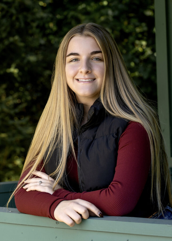 High School Senior girl leaning on rail by Cleary Creative Photography