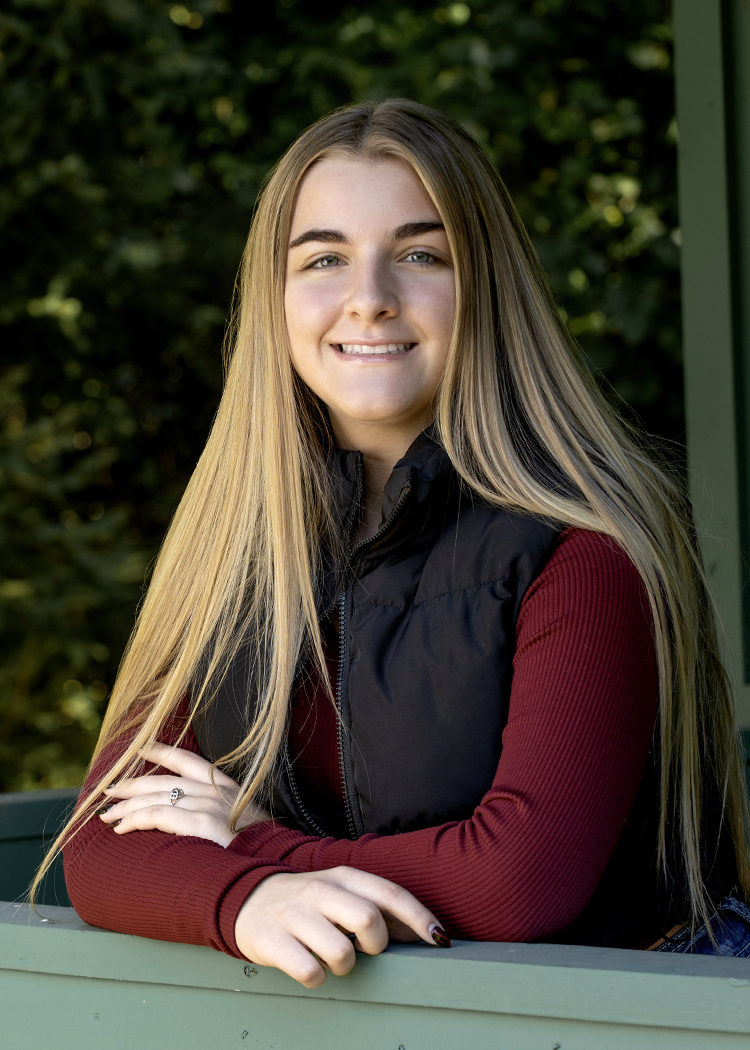 High School Senior girl leaning on rail by Cleary Creative Photography