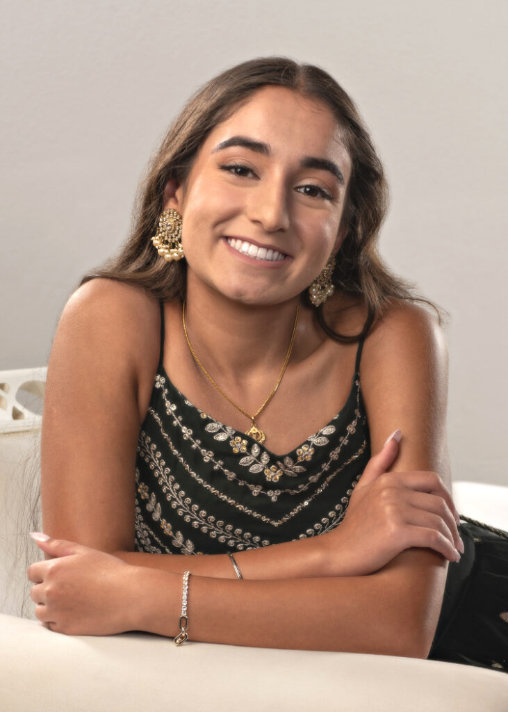 High School girl studio senior portrait leaning on couch by Cleary Creative Photography